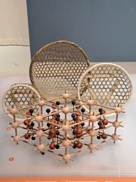 three Japanese baskets with kagome pattern in front of a wooden model build of spheres and sticks in different colors