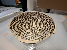 Wooden disc with hexagonal holes revealing moire pattern