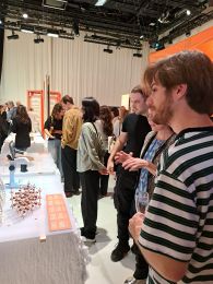 People standing next to exhibition tables